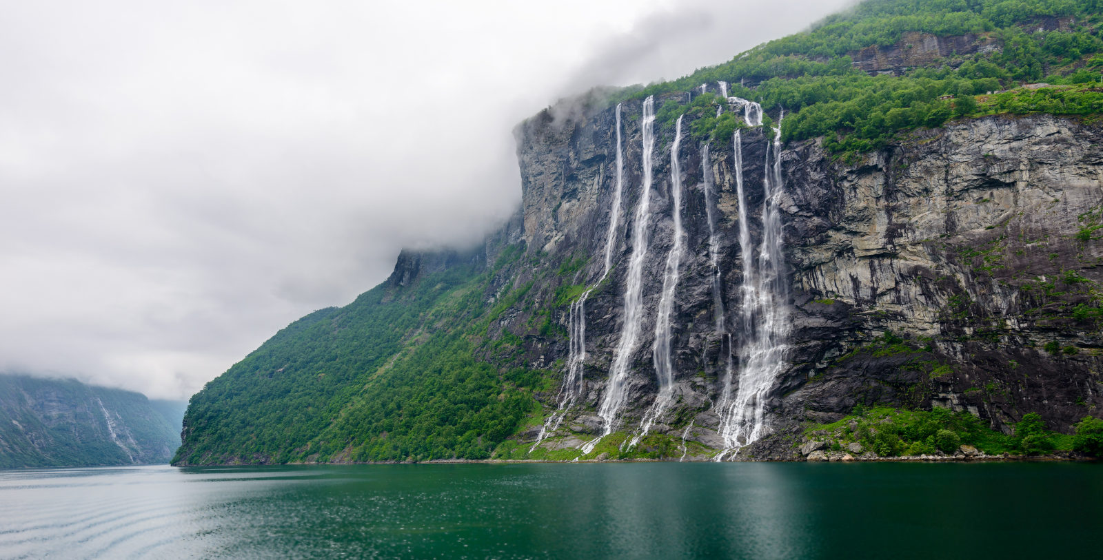 Experience the awe-inspiring power and breathtaking beauty of two of the Geirangerfjord’s most notable waterfalls, the Seven Sisters and the Suitor, during a fjord cruise or kayak excursion.