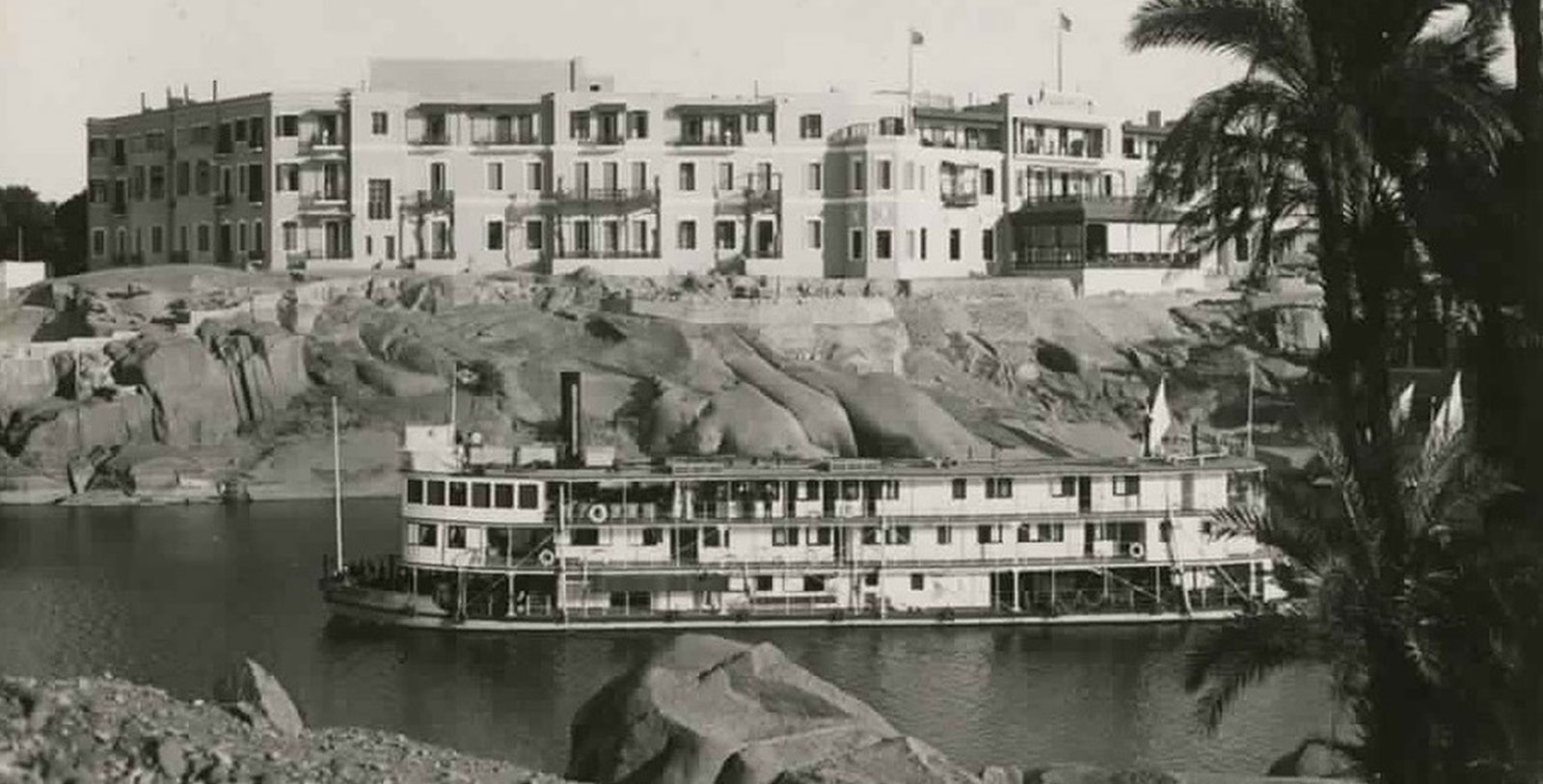 Historical Image of Exterior with Boat in Foreground, Sofitel Legend Old Cataract Aswan, 1899, Member of Historic Hotels Worldwide, in Aswan, Egypt