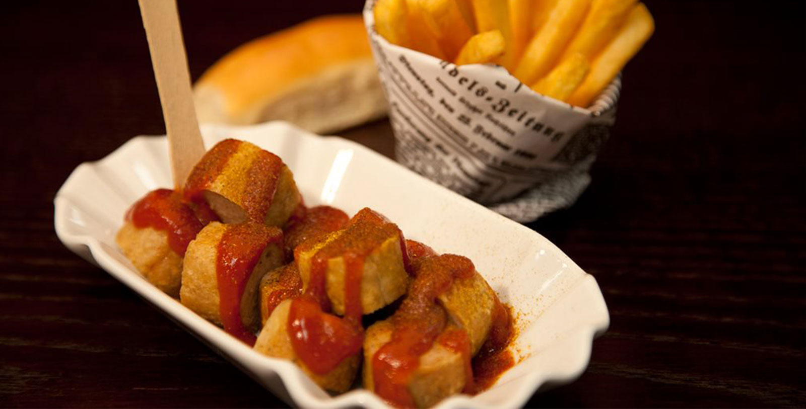 Taste Hotel Adlon's signature Currywurst, a local classic dating back to 1949.
