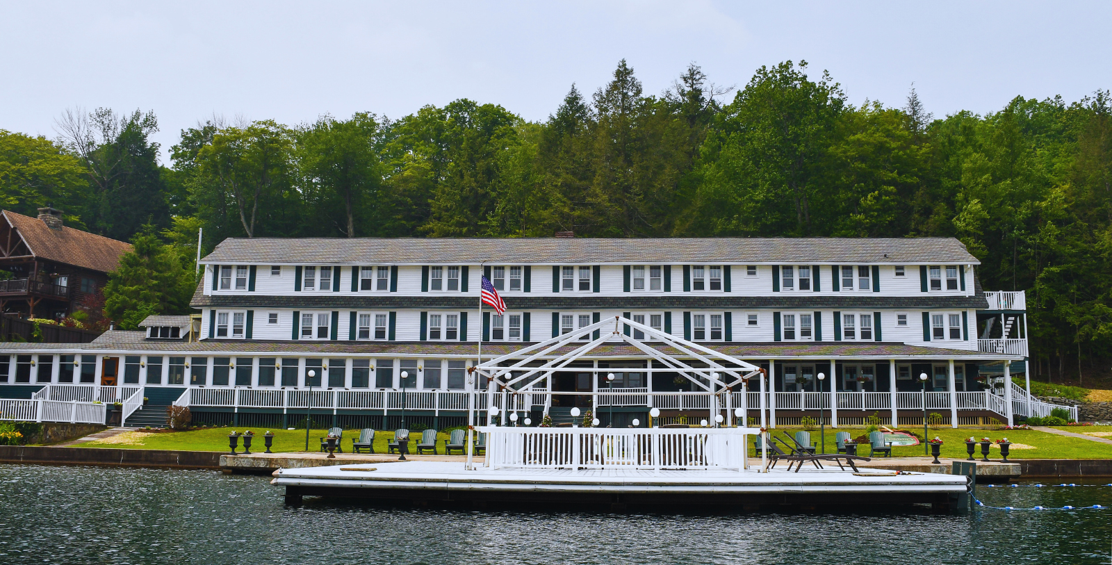 Image of Oquaga Lake and exterior of The Chestnut Inn, 1927, Member of Historic Hotels of America since 2023, in Deposit, New York