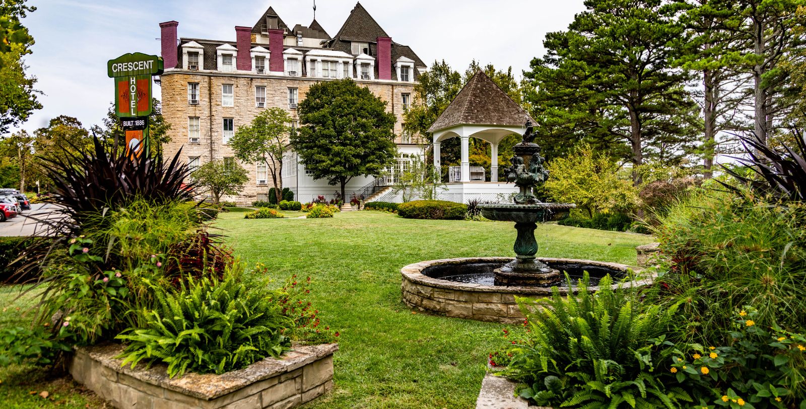 Image of Hotel Exterior with Flowers at the 1886 Crescent Hotel & Spa, Member of Historic Hotels of America, in Eureka Springs, Arkansas, Explore