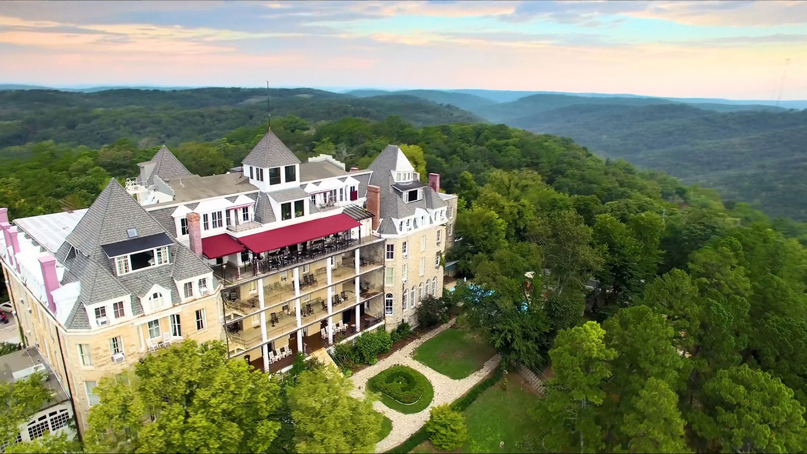 Image of Hotel Exterior with Flowers at the 1886 Crescent Hotel & Spa, Member of Historic Hotels of America, in Eureka Springs, Arkansas, Explore