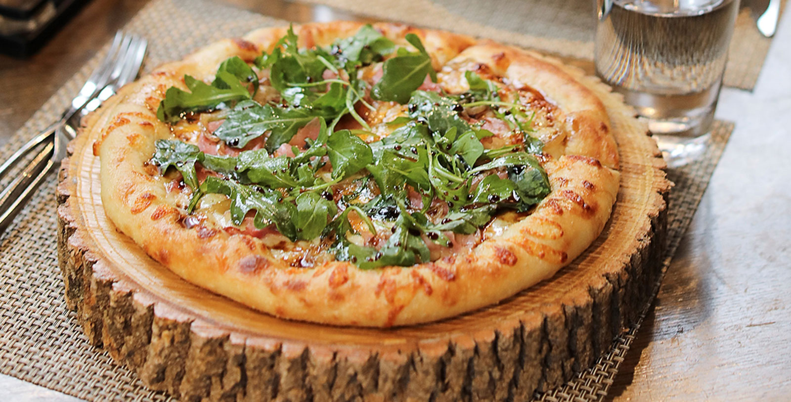 Taste some delicious craft pizza at Woody's.
