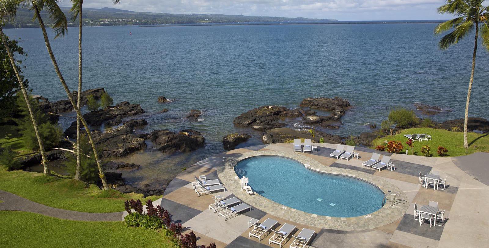 Image of pool and ocean at Grand Naniloa Hotel Hilo, a DoubleTree by Hilton, 1939, Member of Historic Hotels of America, in Hilo, Hawaii, Explore