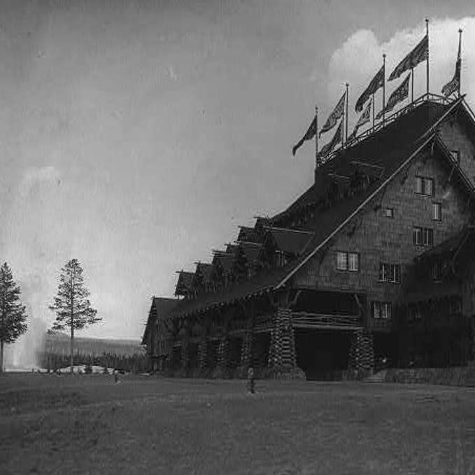 Historical Image of Exterior with Old Faithful Geyser, Old Faithful Inn, 1904, Member of Historic Hotels of America, in Yellowstone National Park, Wyoming.