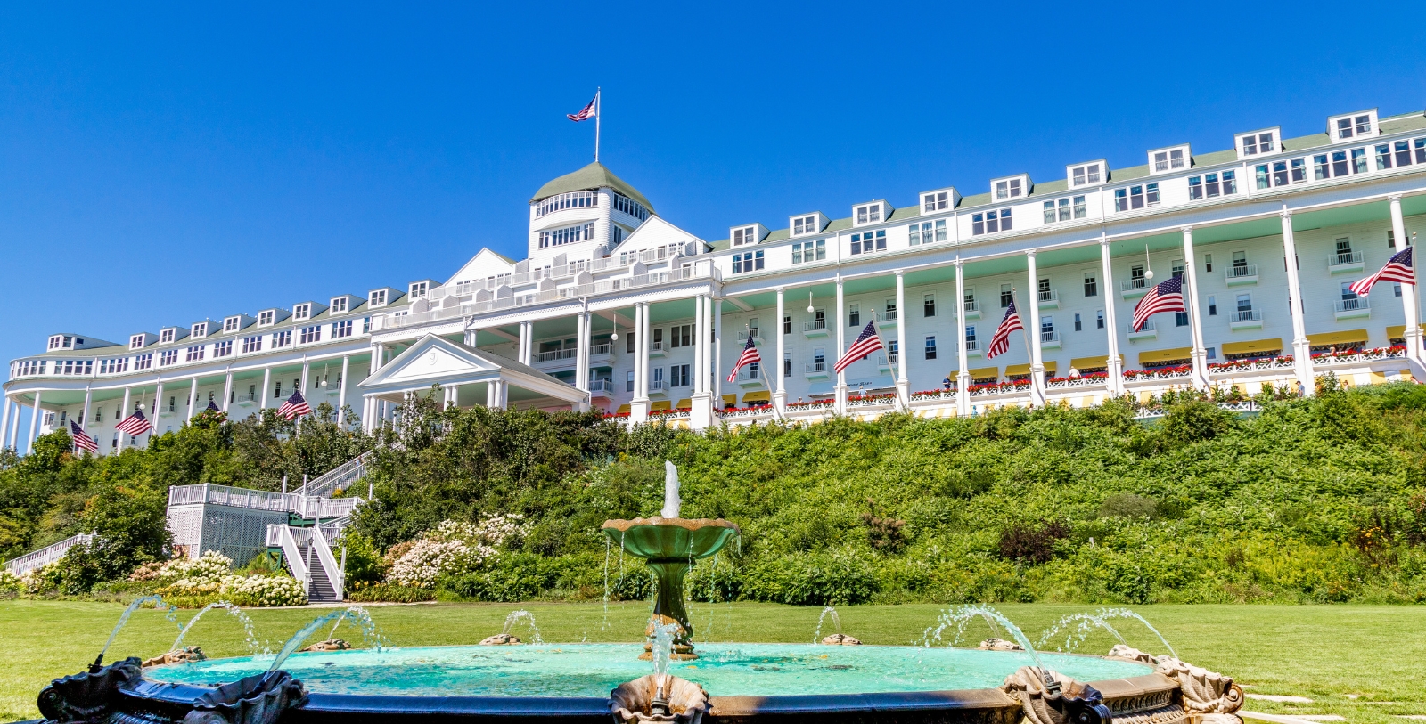 Historic images of people standing on porch at Grand Hotel, 1887, Member of Historic Hotels of America, in Mackinac Island, Michigan, Discover