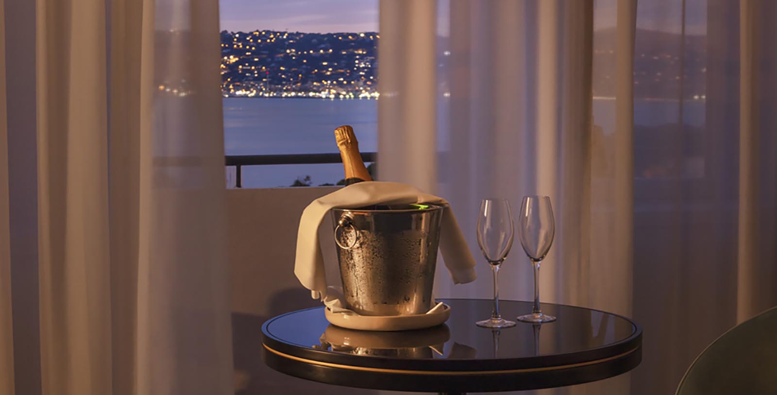 Taste a flute of champagne while enjoying the dazzling lights and shimmer of a Mediterranean evening.