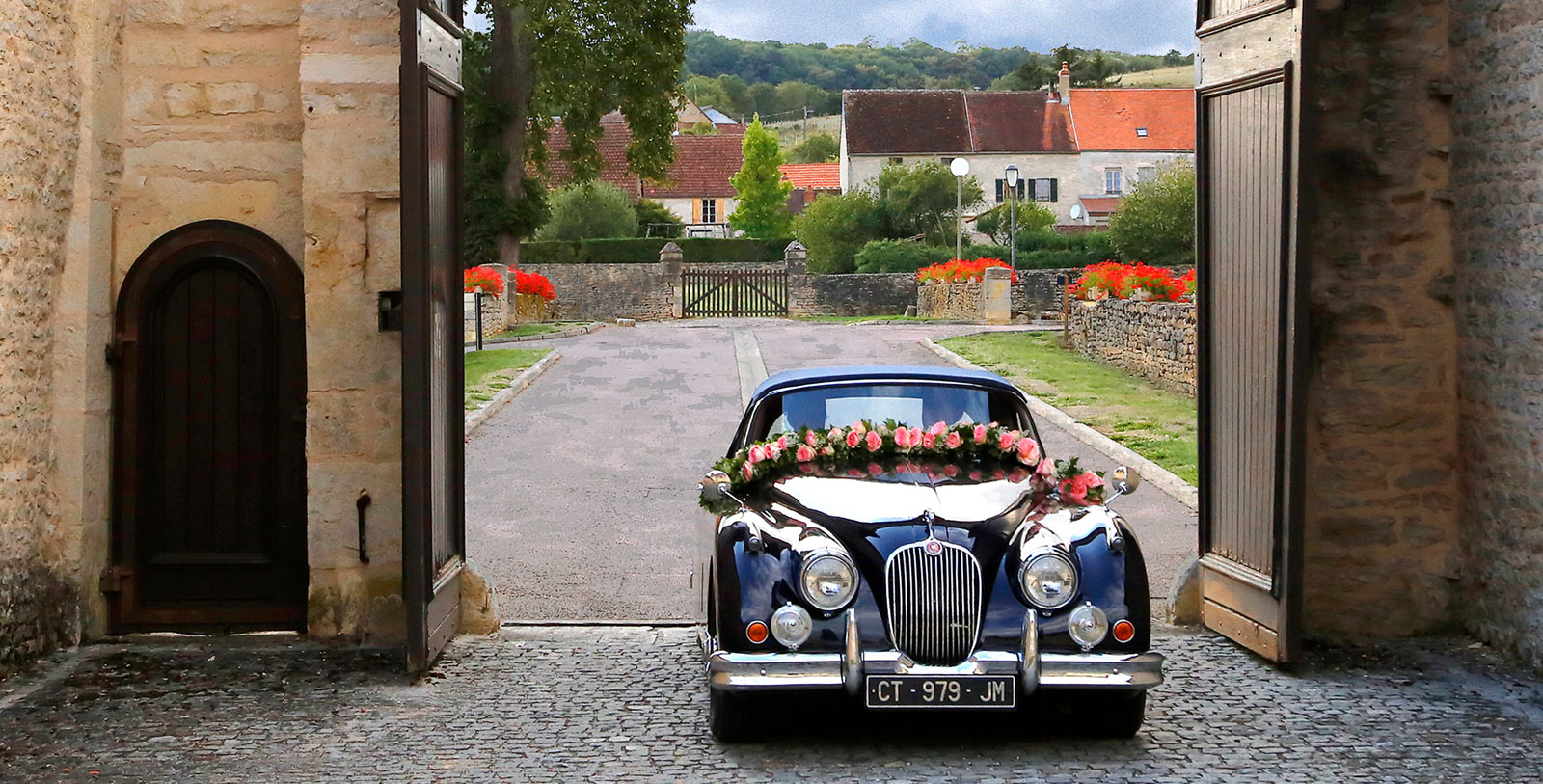 Image of a car decorated for a wedding and driving into the front entrance of Hôtel Golf Château de Chailly, 16th century, a member of Historic Hotels Worldwide in Chailly-sur-Armançon, Burgundy, France