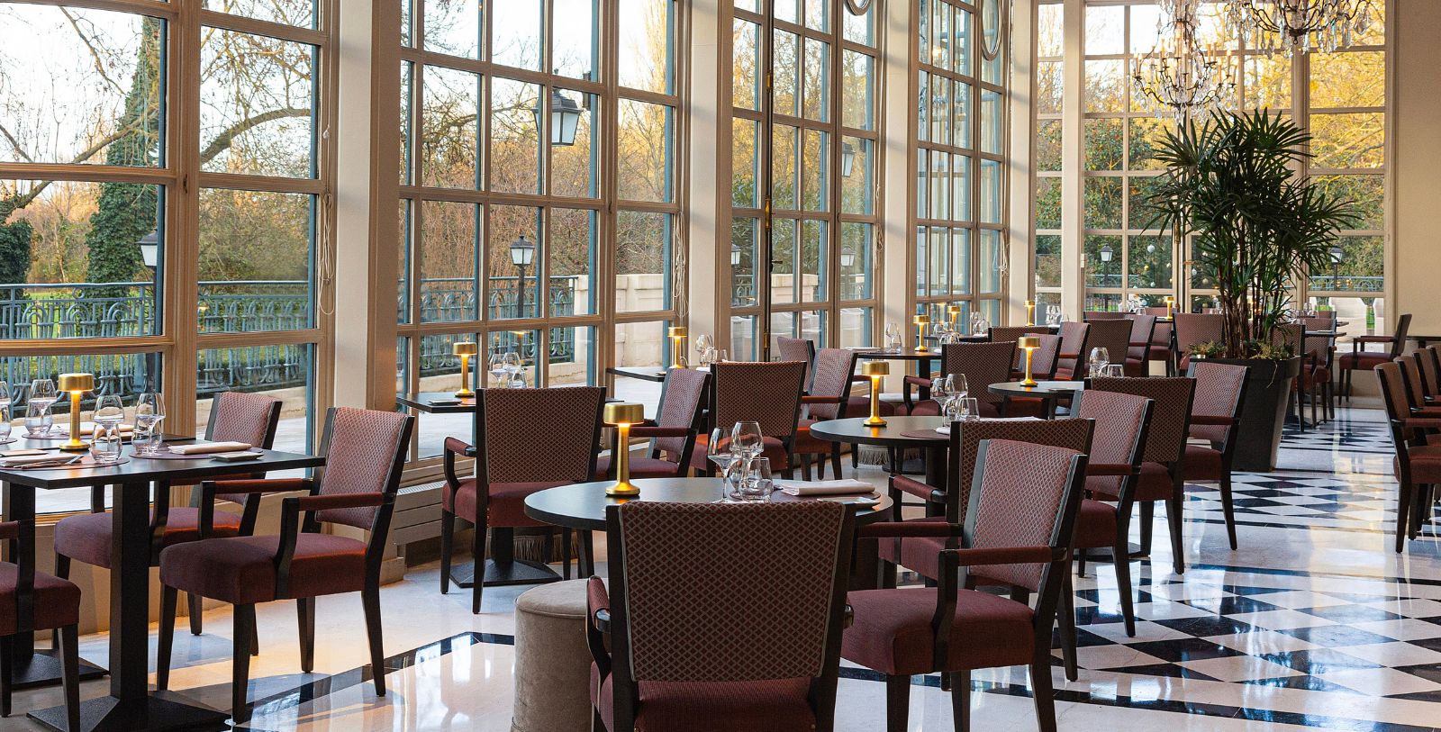 Image of La Véranda dining area at Waldorf Astoria Versailles- Trianon Palace, 1910, a Member of Historic Hotels Worldwide in Versailles, France.