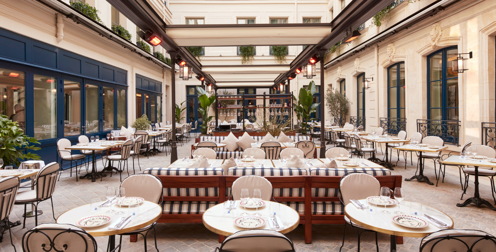 Image of courtyard dining area of La Chambre Bleue at Maison Delano Paris, a member of Historic Hotels Worldwide since 2023, located in Paris, France