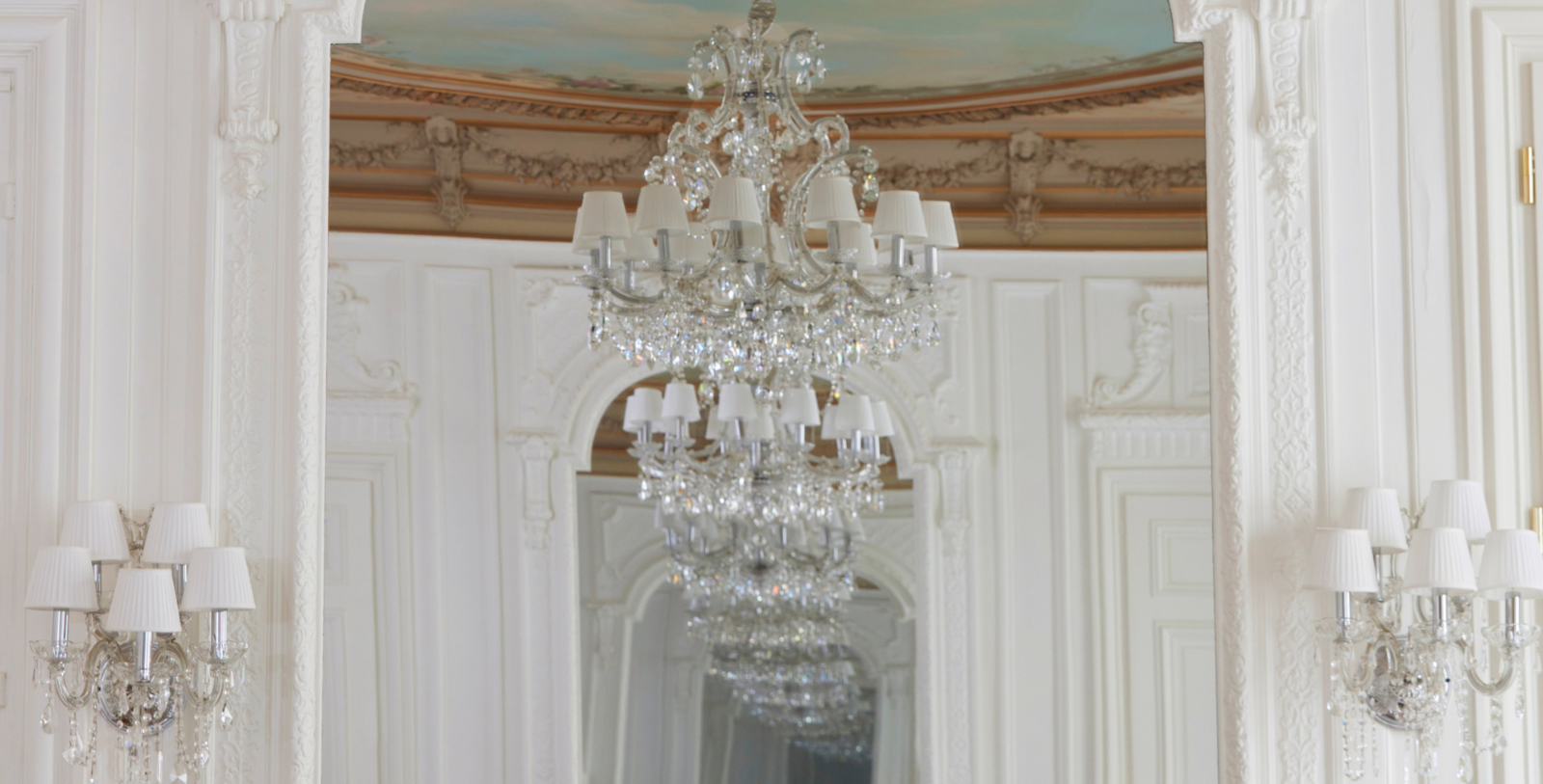 Image of ornate ceiling with chandelier of Grand Historic Suite at Maison Delano Paris, a member of Historic Hotels Worldwide since 2023, located in Paris, France