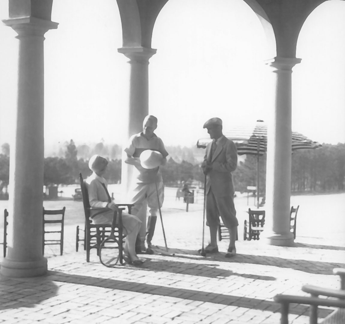 Historical Image of Two Golfers and One Tennis Player Seated on the Clubhouse Patio, Pinehurst Resort, 1895, Historic Hotels of America, in Pinehurst, North Carolina.