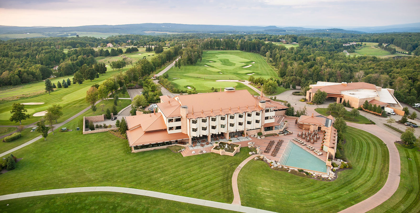 Image of Aerial View of Hotel at The Lodge at Nemacolin Woodlands Resort, 1968, Member of Historic Hotels of America, in Farmington, Pennsylvania, Explore