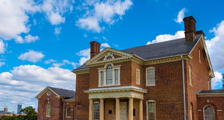 Image Of Mount Clare, A Georgian, Brick Center Block Mansion Built In 1756 With Symmetric Wings. The Wings Are Connected By Hyphens That Were Built To Replace Original Outbuildings In 1908.