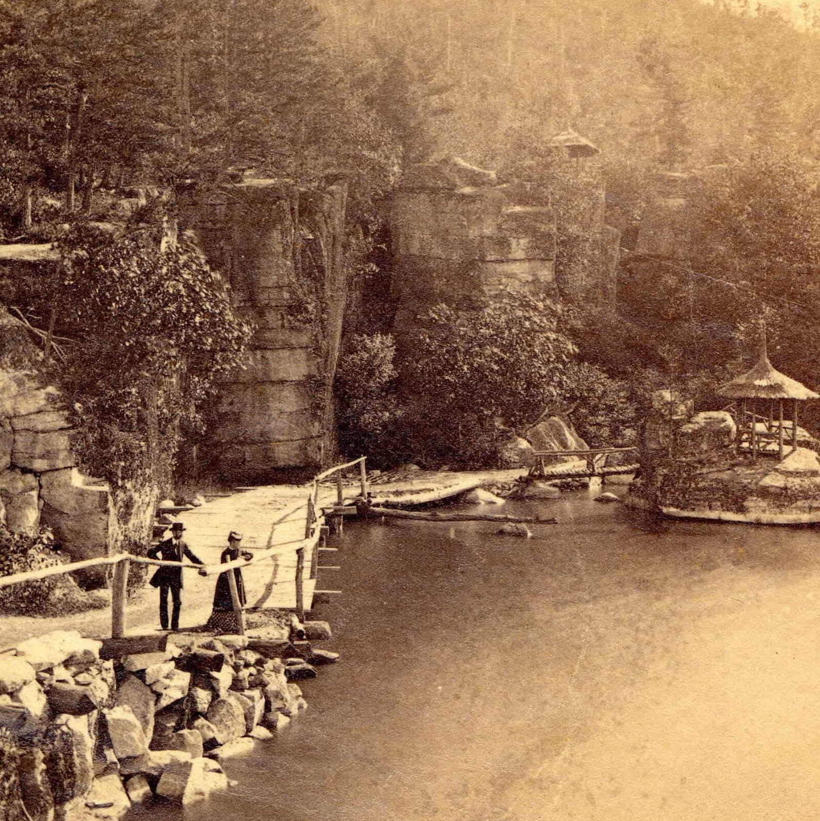 Historical Image of Couple in Nature Preserve Circa 1880s, Historical Image of Exterior and Gardens Circa 1901, Mohonk Mountain House, 1869, Member of Historic Hotels of America, in New Paltz, New York.