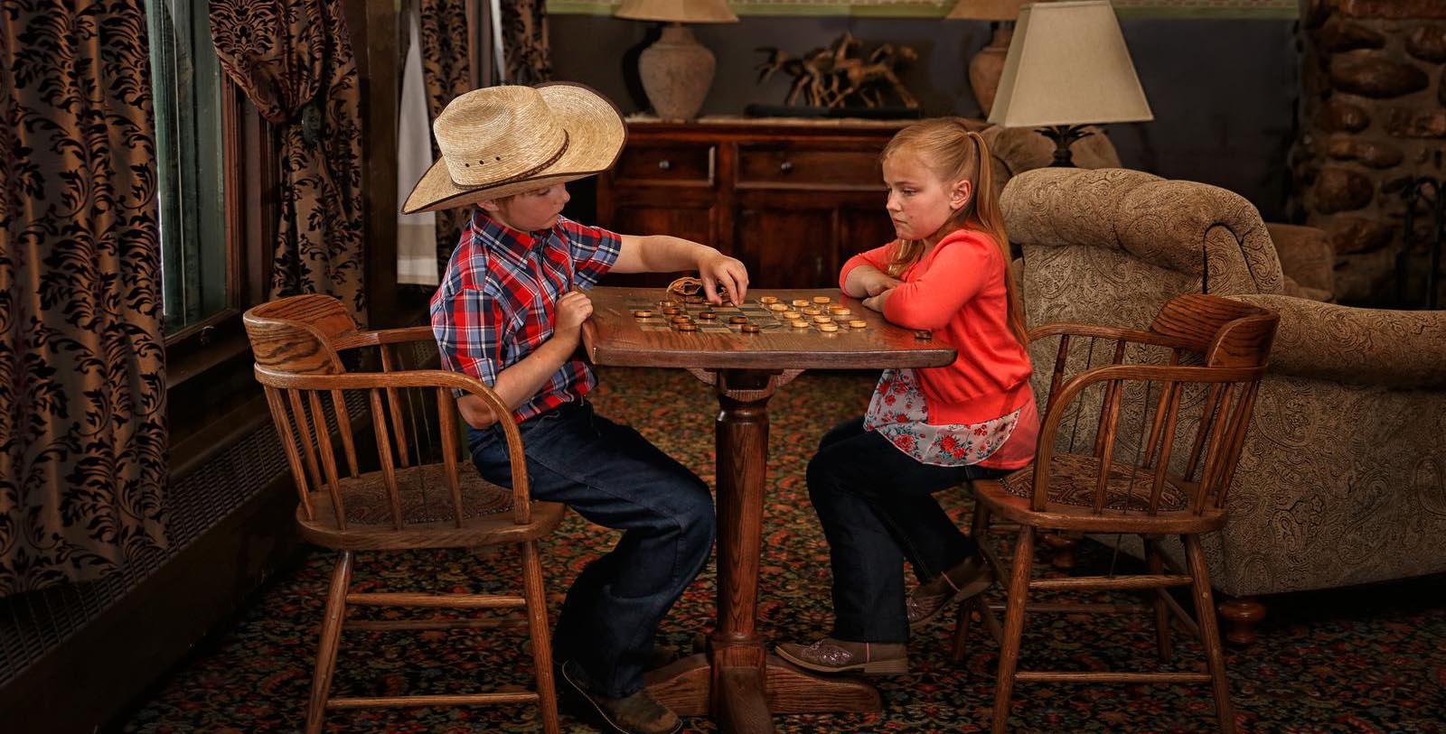 Image of Children Playing Checkers in Seating Area Sheridan Inn, 1893, Member of Historic Hotels of America, in Sheridan, Wyoming, Explore
