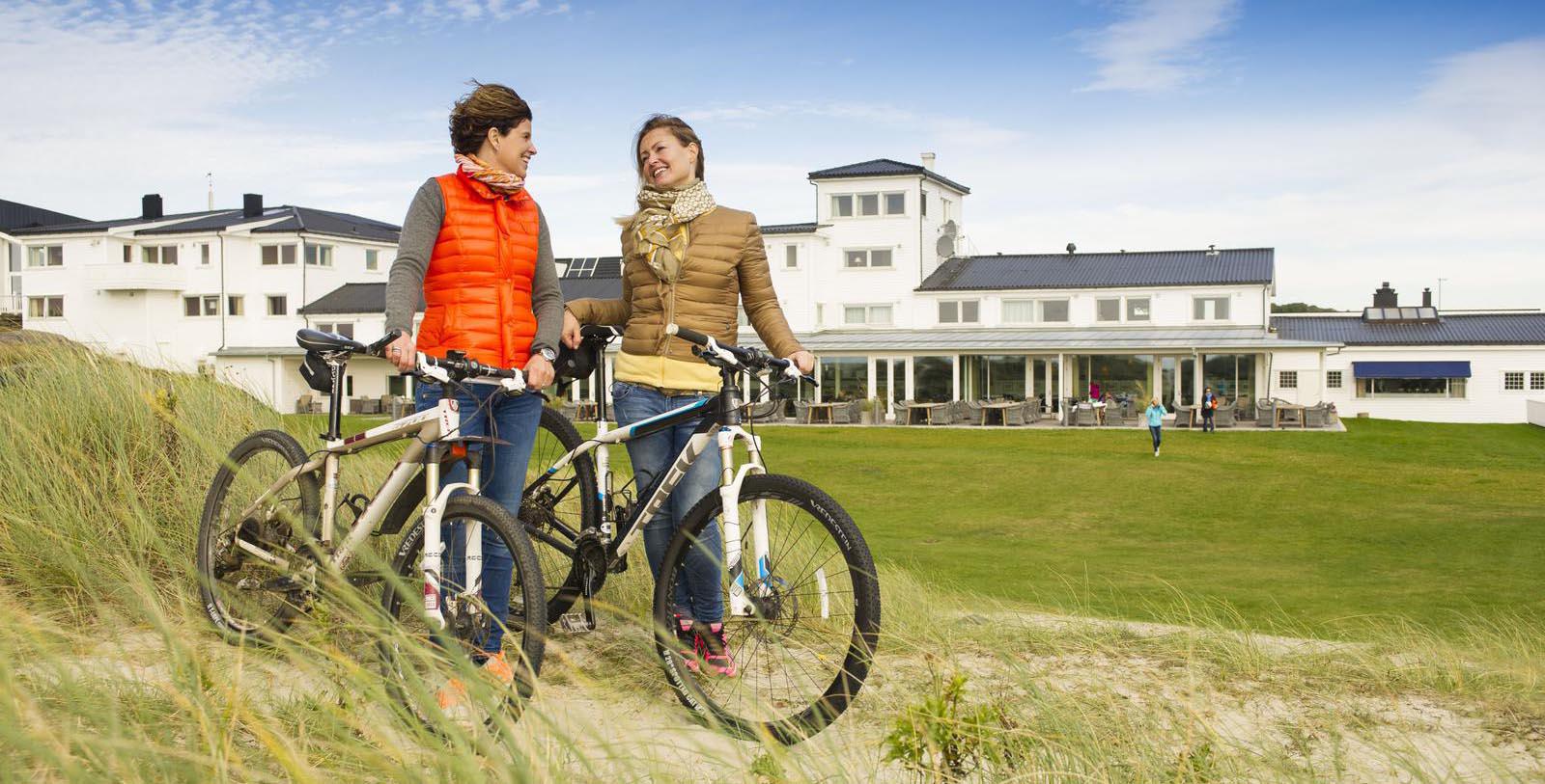 Image of Two Guests With Bikes Outside Sola Strand Hotel, 1914, Member of Historic Hotels Worldwide, in Sola, Norway, Explore